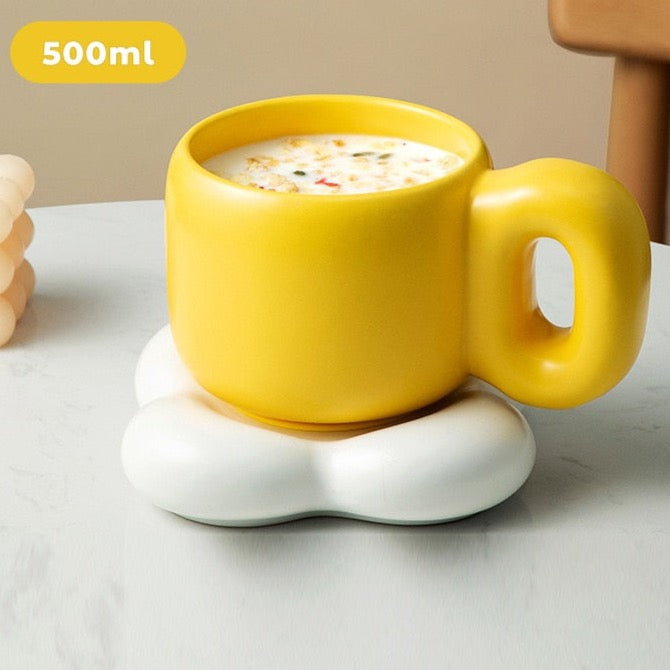 Yellow chunky handle ceramic mug with white plate