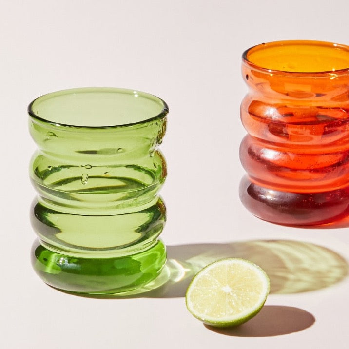 Green and orange colored drinking glasses 