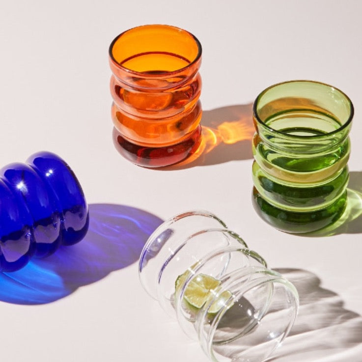 Colorful glassware in cobalt blue, orange, green and clear